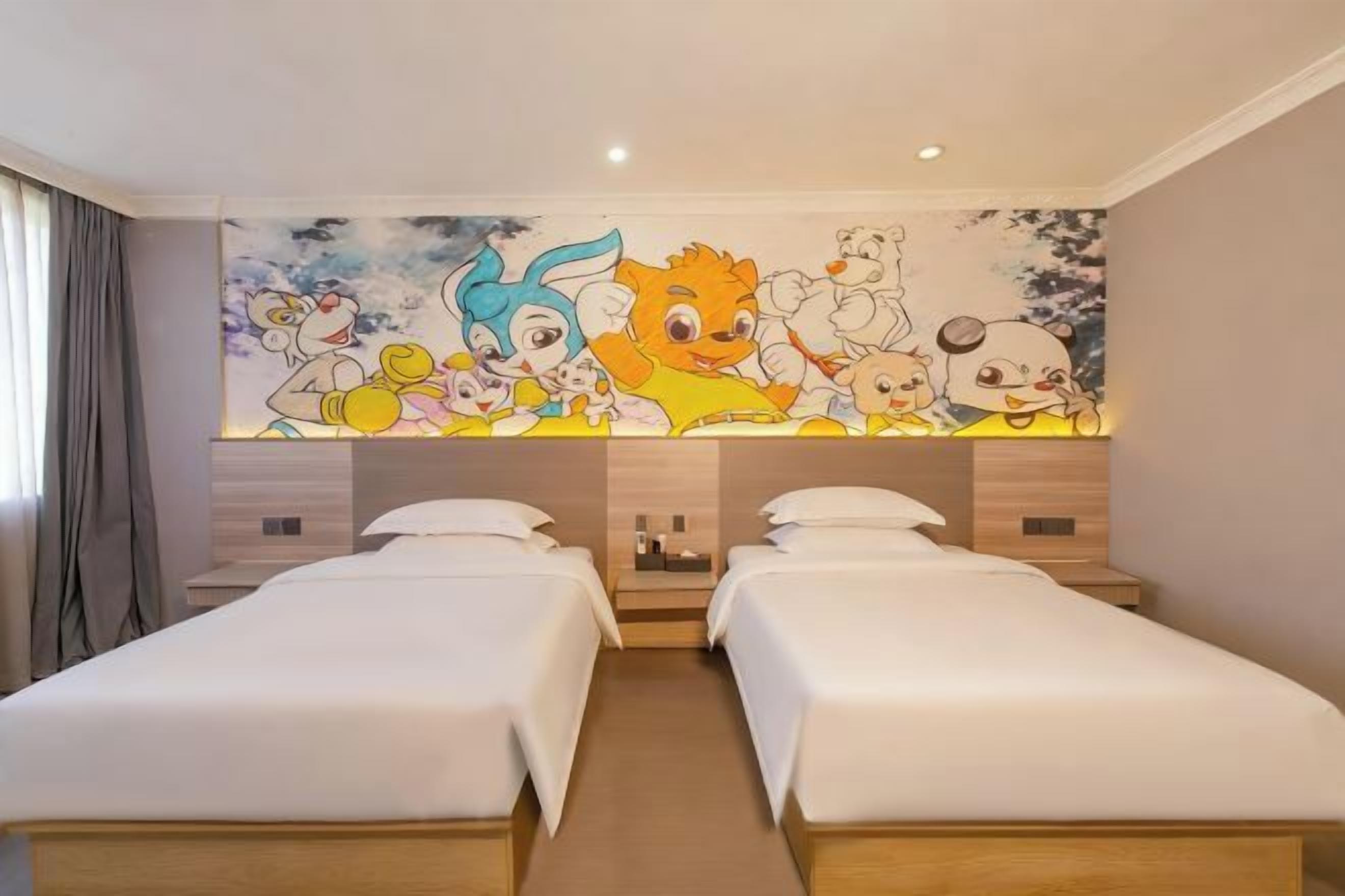 A hotel room with two single beds, a mural on the wall, and a wooden headboard.