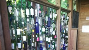A wall of various wine bottles displayed vertically.