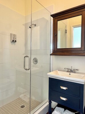 Junior Studio, 1 King Bed, Partial Ocean View | Bathroom | Shower, hair dryer, towels, soap