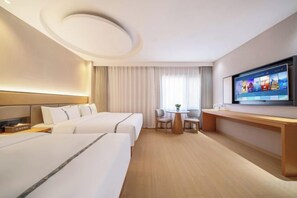 A hotel room with two beds, a desk, a TV, and a window with curtains. - Shangji Hotel (Shanghai Hongqiao Airport ,West Xianxia Road ) (Shanghai)
