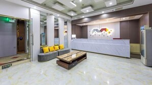 A modern lobby with a reception desk, seating area, and a marble floor. - Shangji Hotel (Shanghai Hongqiao Airport ,West Xianxia Road ) (Shanghai)