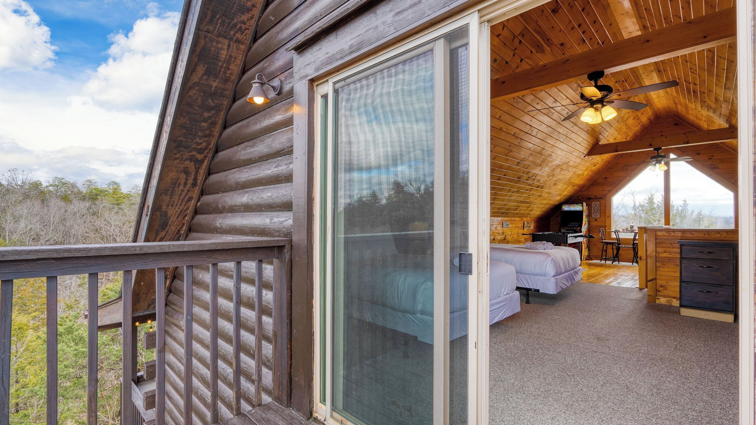 A log cabin with a bedroom, a dining area, and a balcony.