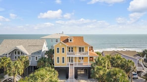 A coastal residential area with houses, a staircase leading to a dock, and a view of the ocean. - Oceanfront w/ Pool, Panoramic Deck Views, 5bdr Folly Ocean Breeze by Avantstay (Folly Beach)