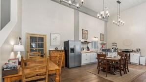A spacious kitchen with a dining area, wooden furniture, and modern appliances. - Pond Property with Mountain Views (Bayfield)