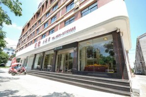 A hotel with a modern facade, large windows, and a visible entrance. - NOMC Hotel (Xianju)