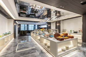A modern hotel lobby with a central reception desk, a glass coffee bar, and a polished marble floor. - Junrui Huasheng International Hotel (Zhuzhou)