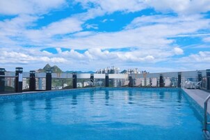 Una piscina en la azotea con vistas despejadas al horizonte de la ciudad.