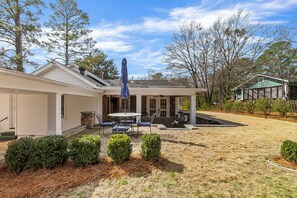 A residential property with a covered patio, a garage, and a small house. - Bellwood Beauty (Northport)