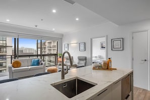 Enjoy a spacious kitchen with a large island and sink, perfect for meal preparation and casual dining.