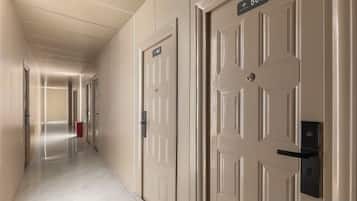 A hotel corridor with doors numbered 565 and 566.
