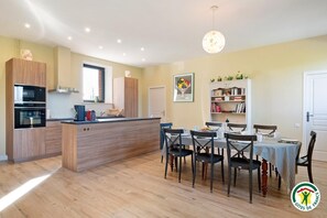 Enjoy meals in the kitchen with a central island and dining area featuring a table for four.