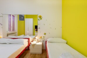 A hotel room with two beds, a mirror, a nightstand, and a window with curtains. - GIACOSA, 71 – Spacious apartment for 6 (Milano)
