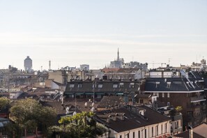 A cityscape with multiple buildings, including a prominent tower and a building with a spire.