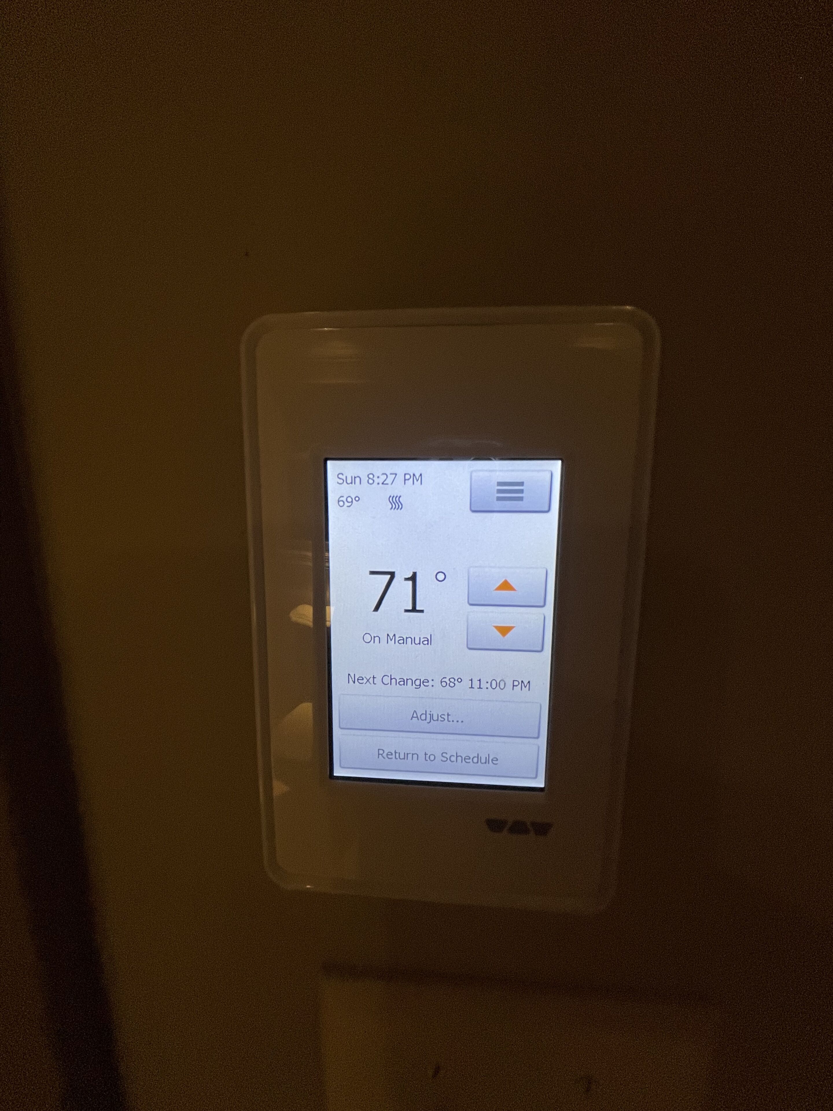 A thermostat displaying the current temperature of 71°F, set to manual mode, with a next change scheduled for 68°F at 11:00 PM.
