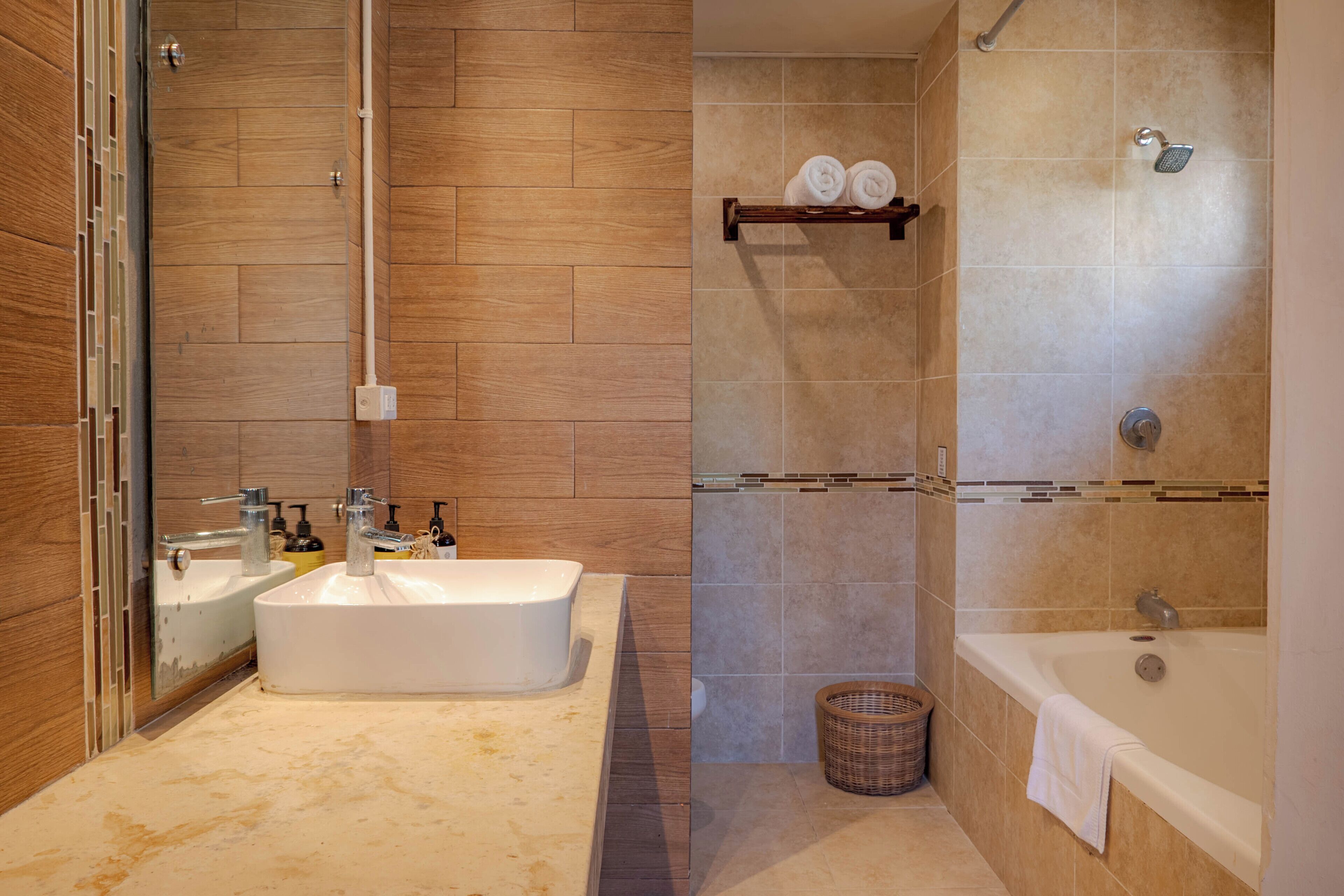 A modern bathroom with a large bathtub, a separate shower area, and a vanity with two sinks.