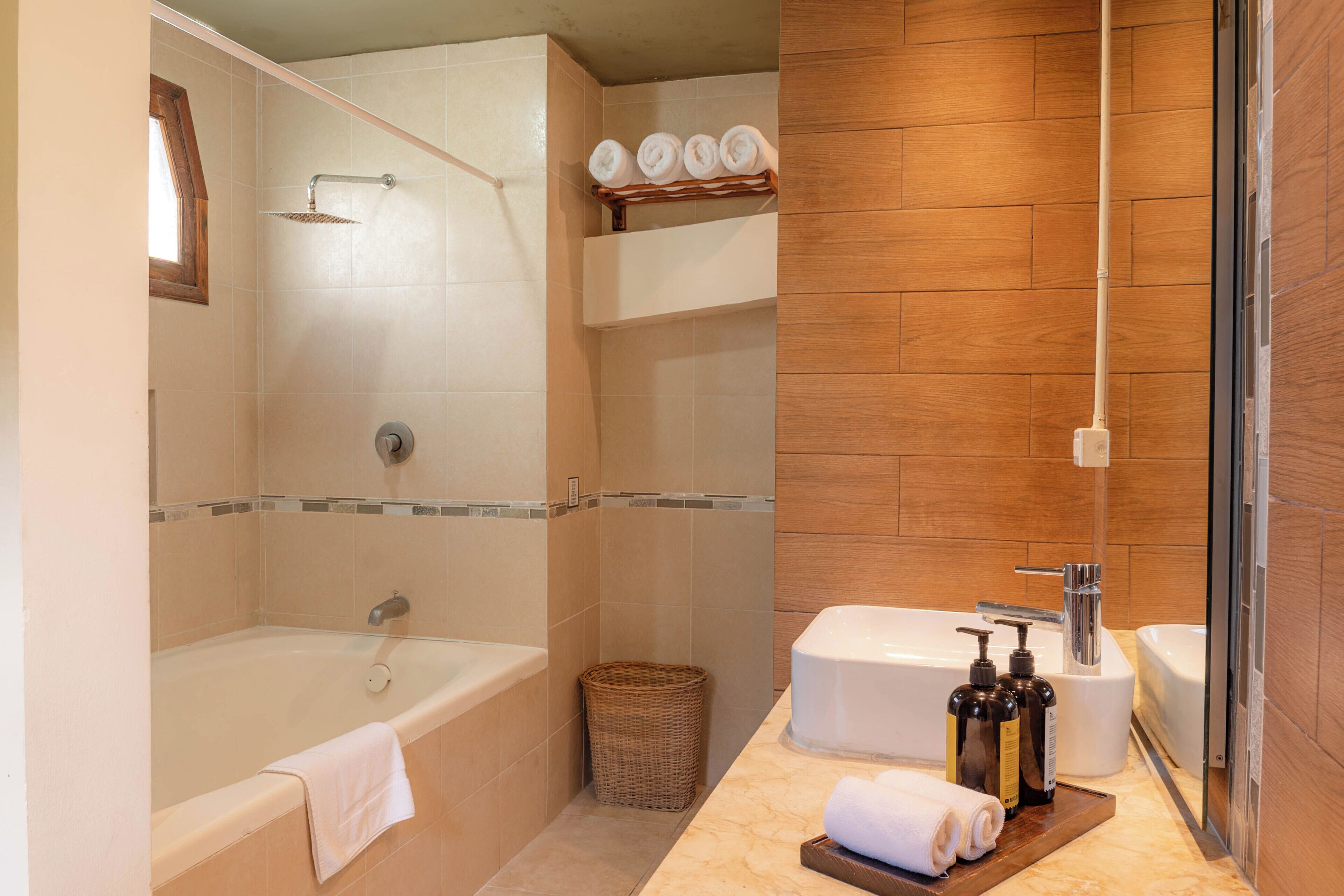 A bathroom with a bathtub, a shower, a sink, and a toilet.