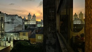 A cityscape with historic buildings and a prominent church with two towers.