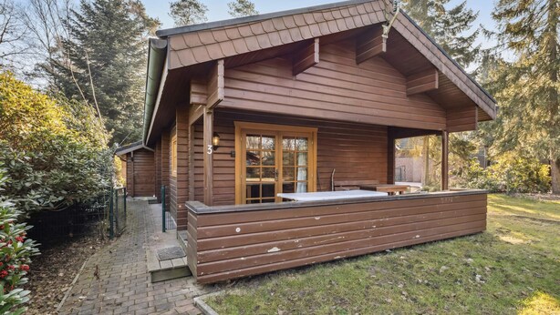 A wooden cabin with a large deck, a glass door entrance, and a number '3' sign. - Pet friendly home in Haren with WiFi (Haren)