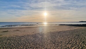 A beach with a clear sky and the sun low on the horizon. - Pet friendly home in NERE (NERE)