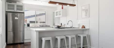 Fridge, dishwasher, coffee/tea maker, cookware/dishes/utensils