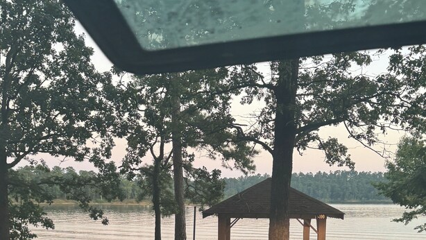 A gazebo with a dirt ground and trees around it. - Cozy 2-bedroom cabin with WiFi, AC in charming Murfreesboro on Lake Greeson. (Murfreesboro)