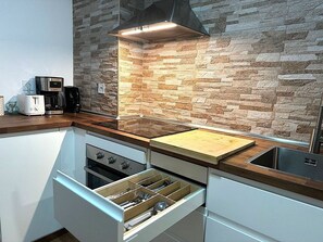 Enjoy cooking in this well-equipped kitchen with an oven, microwave, and coffee maker.