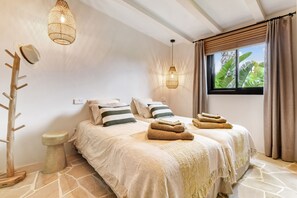 A bedroom with a bed, two hanging lights, a window with curtains, and a view of greenery outside. - Villa 'Las Brisas' with Mountain View, Wi-Fi and Air Conditioning (Jávea)