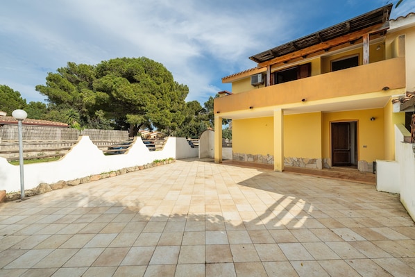 A two-story building with a tiled patio area.