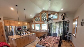 A spacious kitchen with wooden cabinets, stainless steel appliances, and a large island.