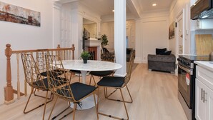 A modern kitchen with white cabinetry, a marble countertop, and a built-in oven. - Elegant 4BR Luxury Duplex in chic Upper West Side (New York)