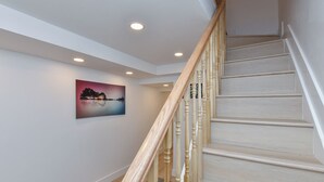 A staircase with wooden balusters and a light-colored finish, leading to an upper floor. - Elegant 4BR Luxury Duplex in chic Upper West Side (New York)