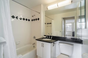 A bathroom with a bathtub, a sink, and a toilet. There is a shower curtain, a mirror, and a window. - Classic NYC Living | Upper West Side | Rooftop (New York)