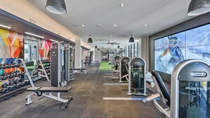 A gym with various exercise equipment, including dumbbells and weight machines.