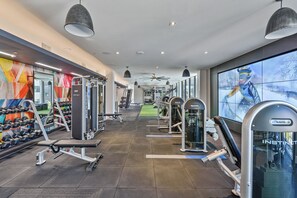 A gym with various exercise equipment, including dumbbells and weight machines.