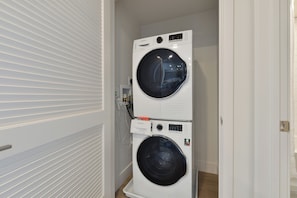 A laundry room with two stacked front-loading washing machines.