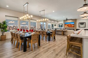 A spacious dining area with a large table, multiple chairs, and pendant lighting. - Pecan Valley 5205/5193|2 Private Pools&Spas, Private Pickleball Court, Game Room (Hurricane)