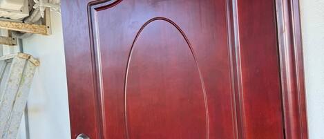 A red door with a keyhole and a small window.