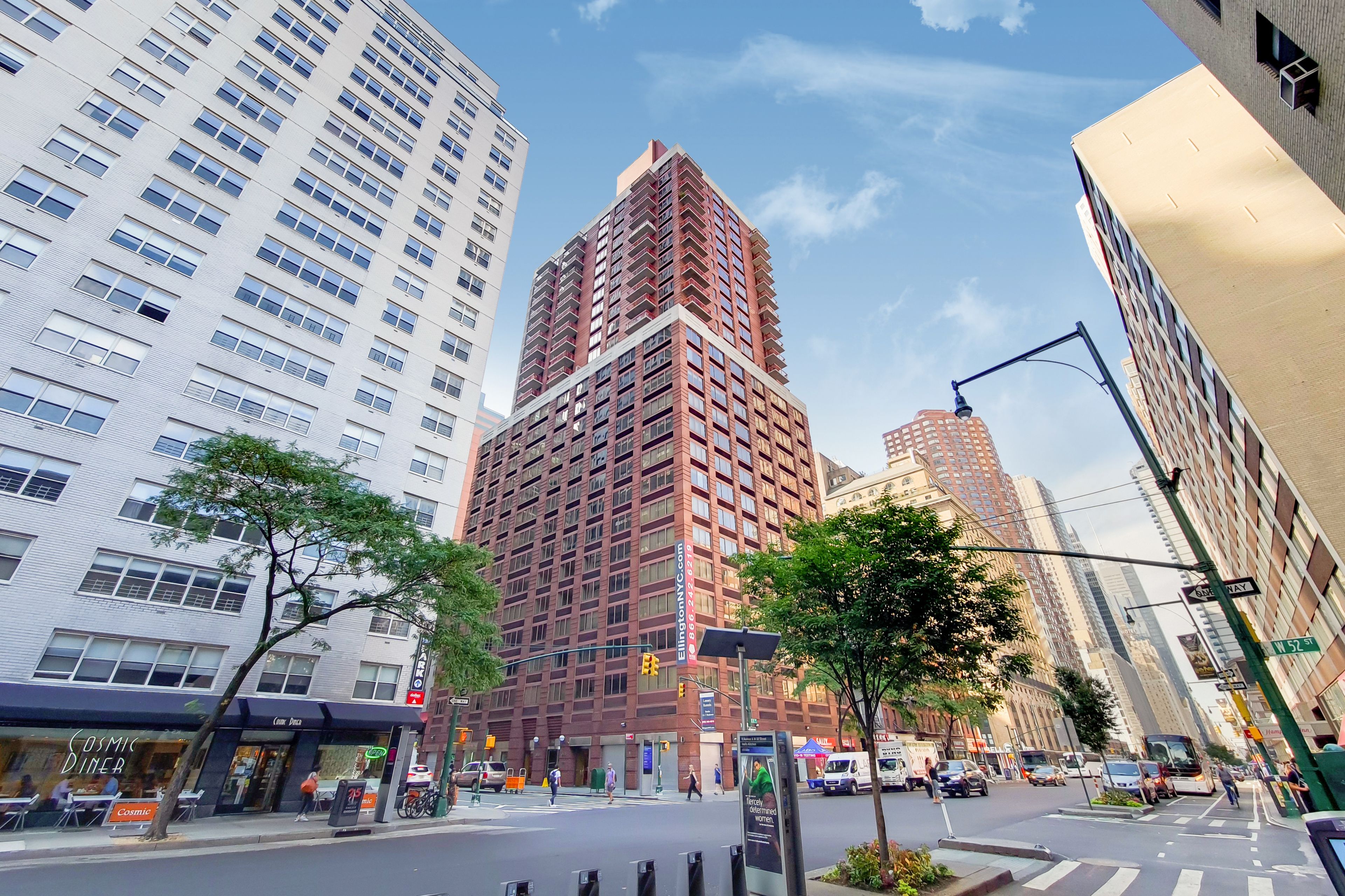 A high-rise building with multiple floors, large windows, and a prominent entrance.