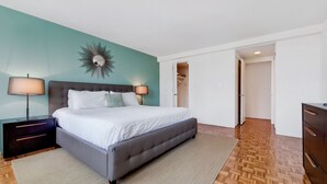 A bedroom with a bed, nightstands, a mirror, and a wardrobe. - Modern One Bedroom Apartment in Boston's Back Bay (Boston)