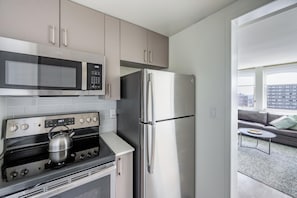 Enjoy cooking and dining in this well-lit kitchen with a city view.