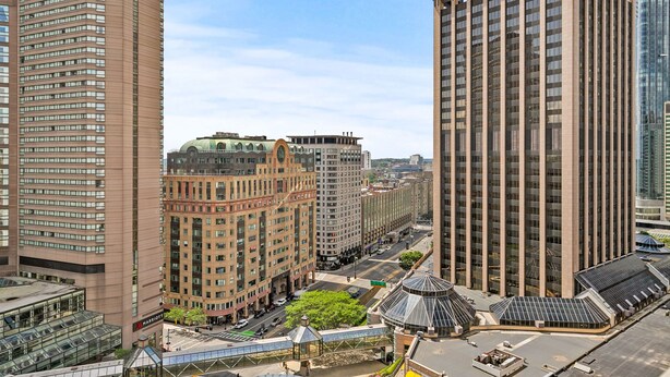 A high-rise hotel with a modern design, featuring a glass facade and a rooftop terrace. - Spacious Apartment in Luxury Back Bay Building (Boston)