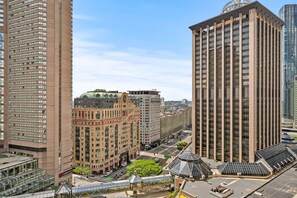 A high-rise hotel with a modern design, featuring a glass facade and a rooftop terrace.
