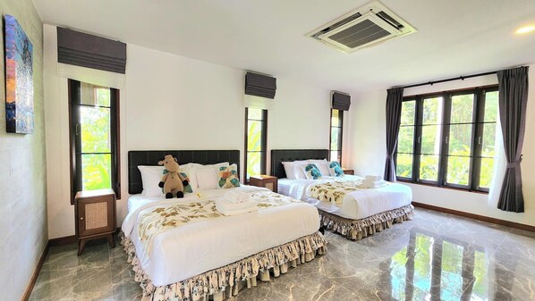 A hotel room with two beds, large windows, a ceiling vent, and a marble floor.