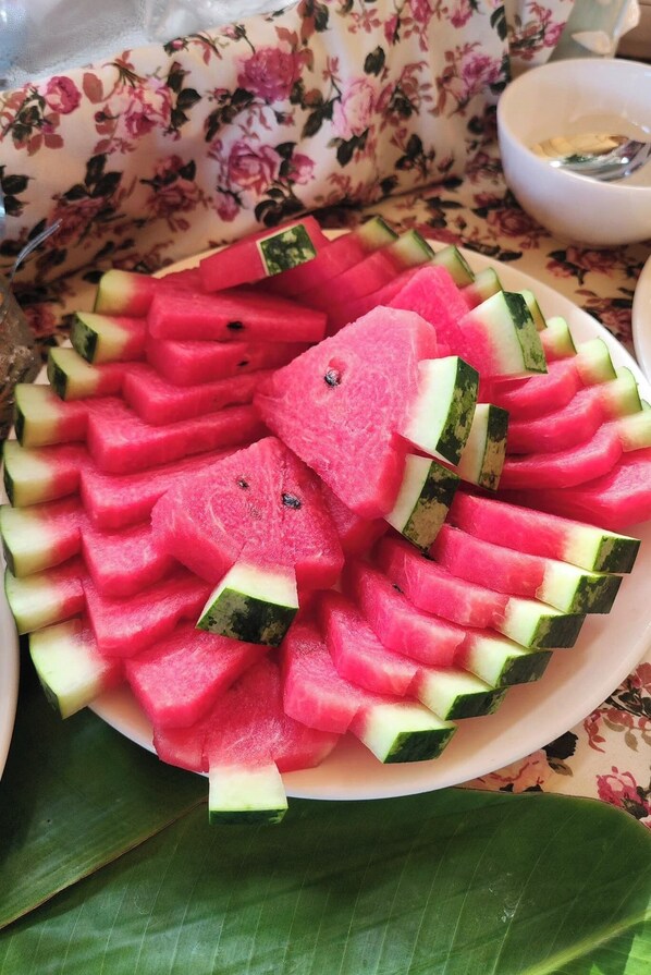 A plate of watermelon slices arranged in a circular pattern on a table. - O yua Resort (Nakhon Nayok)