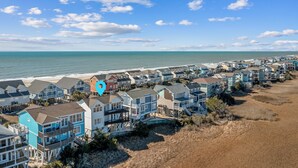 A coastal residential area with houses along the beach, featuring balconies and waterfront views. - "Paradise Palms" 3 Bedroom 3.5 Bath Second Row Home! (Supply)