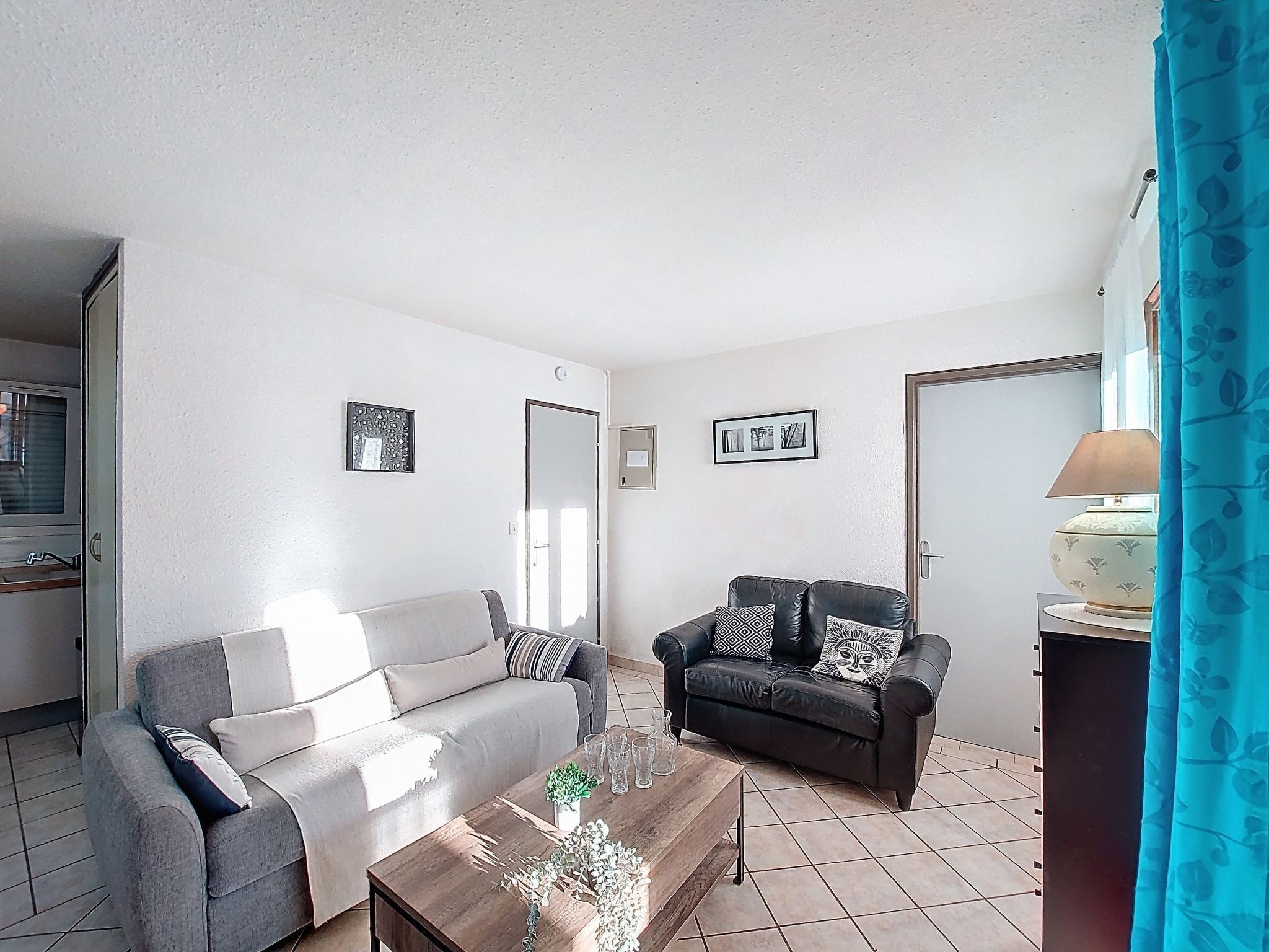 A living room with two sofas, a coffee table, and a TV.