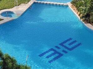A rectangular swimming pool with a clear blue water surface.