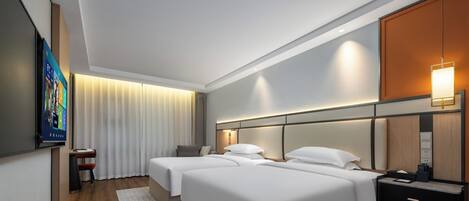 A hotel room with two beds, a TV, a desk, and a wardrobe.