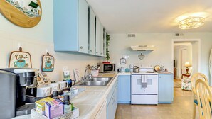 A kitchen with white cabinets, a coffee machine, and a refrigerator. - Fire Pits, Creek View: Historic Virginia Farmhouse (Bealeton)