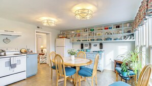 A kitchen with a dining table, chairs, and a refrigerator. - Fire Pits, Creek View: Historic Virginia Farmhouse (Bealeton)